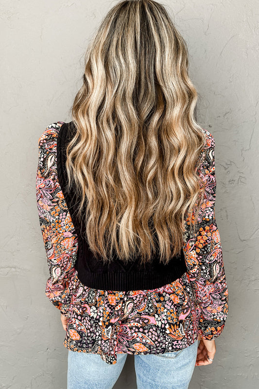 Pull péplum noir à manches florales contrastées