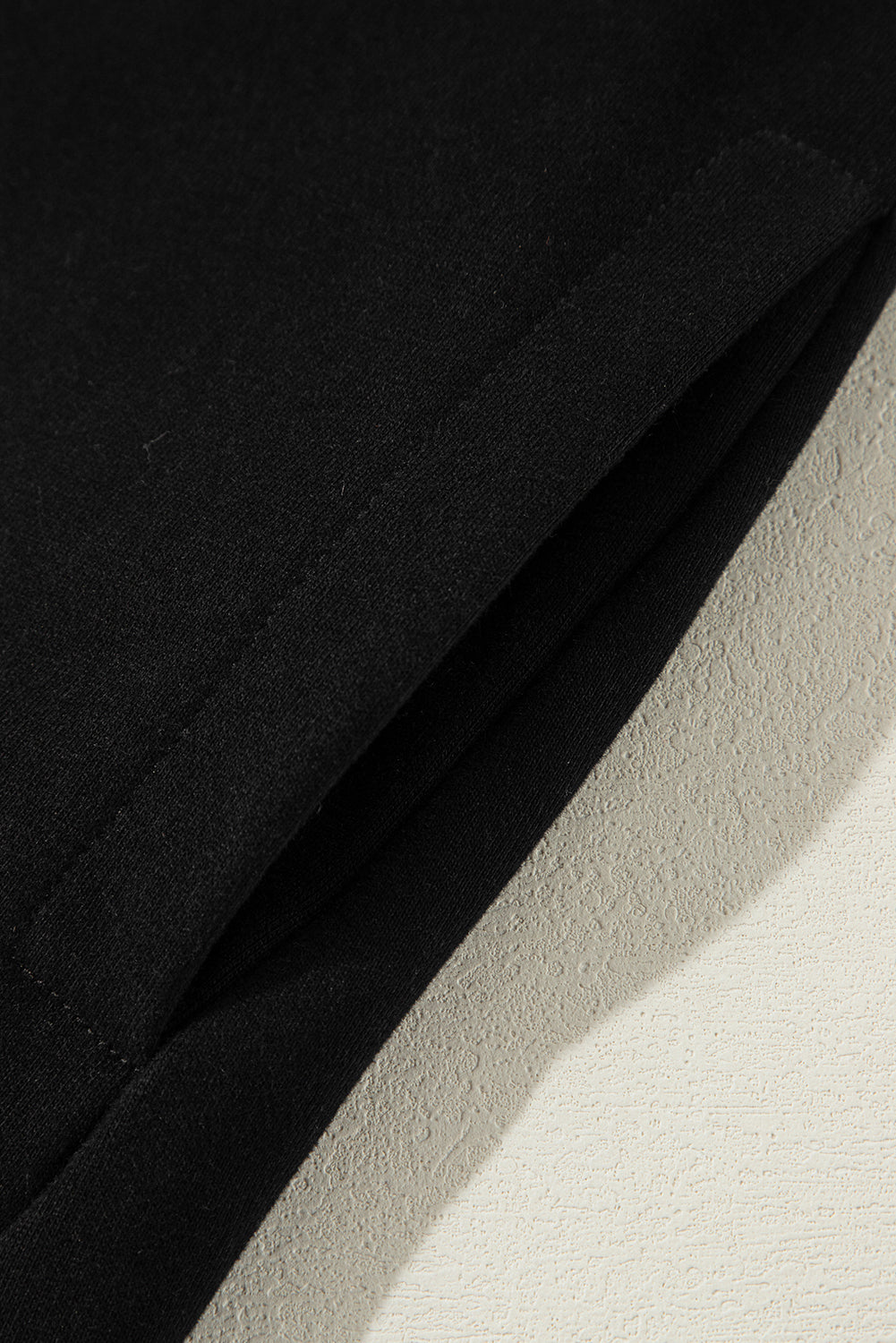 Sweat-shirt noir uni à col rond et ourlet haut-bas