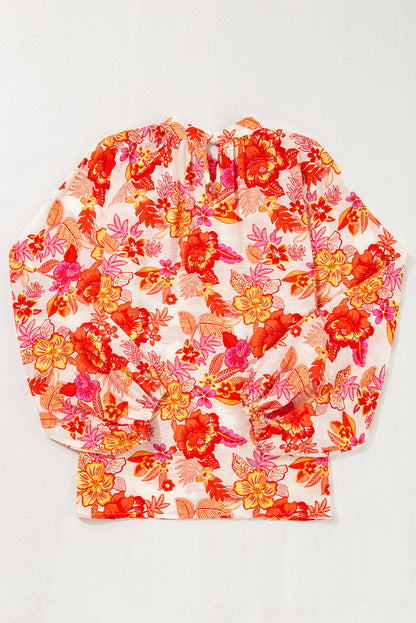 Chemisier orange à imprimé floral, boutons nacrés, manches longues bouffantes et trou de serrure