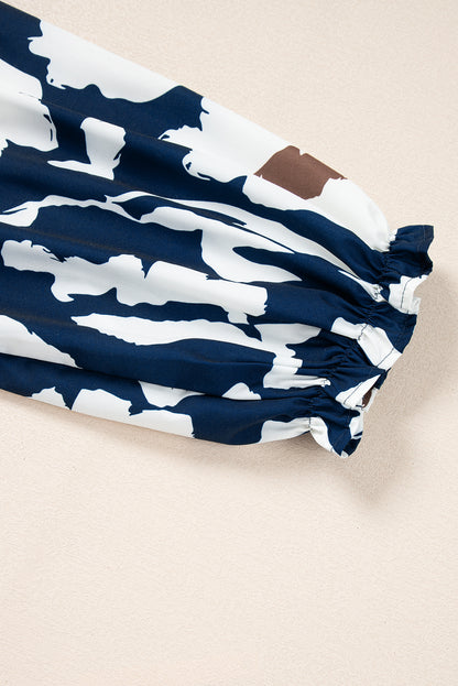 Chemisier bleu voile à imprimé floral abstrait et manches bouffantes à demi-boutons