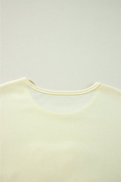 Sweat-shirt beige à manches bouffantes et fleurs en guirlandes