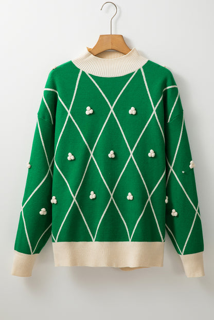 Pull col montant à motif losanges vert foncé avec pompons contrastés