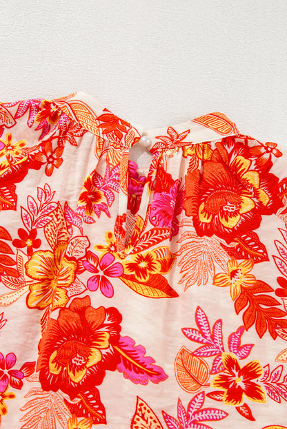 Chemisier orange à imprimé floral, boutons nacrés, manches longues bouffantes et trou de serrure