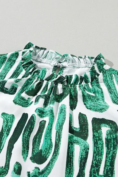 Haut imprimé vert noirâtre à manches bouffantes et col à volants