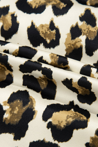 Chemisier péplum à manches bouffantes et nœud papillon sur le devant, motif léopard abricot