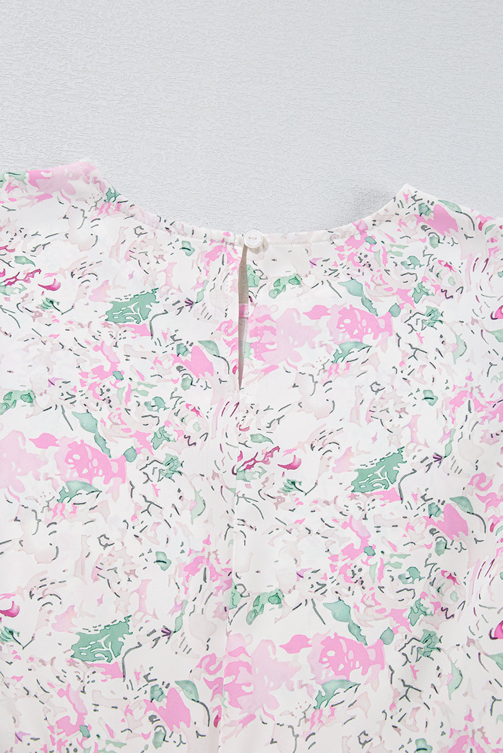 Chemisier babydoll rose à imprimé floral, manches ballon froncées, dos troué