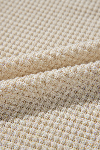 Chemisier péplum beige à imprimé floral gaufré et manches courtes à volants