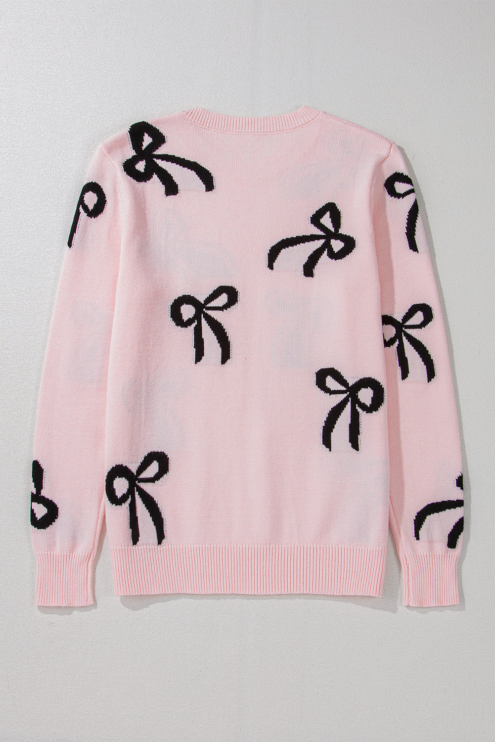 Pull ample en maille rose clair à motif nœud