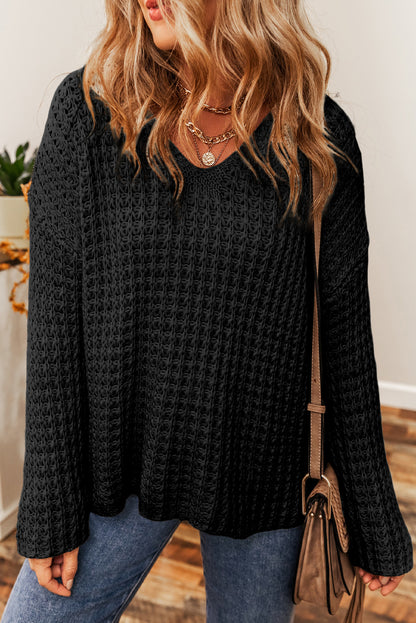 Pull noir à col en V et crochet ajouré 