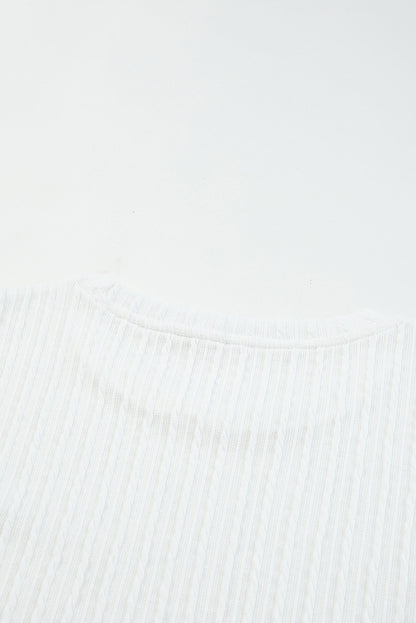 Blusa de punto texturizada con mangas de malla y apliques florales 