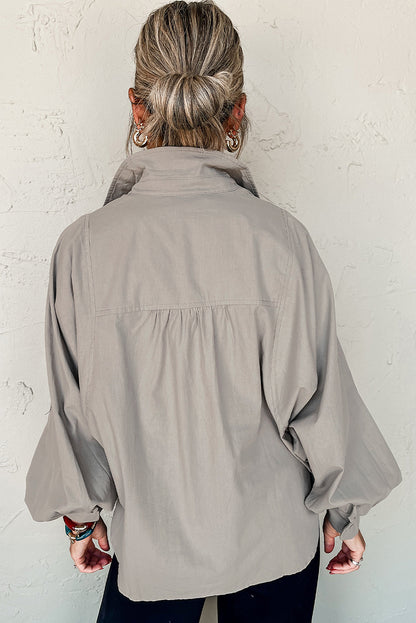 Chemise ample à manches ballon et fentes latérales de couleur unie