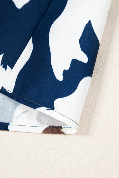 Chemisier bleu voile à imprimé floral abstrait et manches bouffantes à demi-boutons