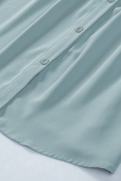 Chemisier boutonné à manches bouffantes de couleur unie