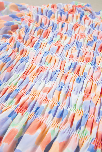 Chemisier rose à imprimé abstrait et à volants