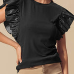 Chemisier en cuir noir à manches volantées et col rond en patchwork