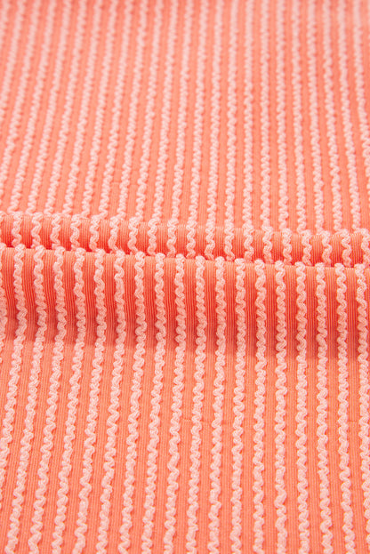 Chemise ample à manches mi-longues et ourlet haut-bas boutonné, couleur pamplemousse orange