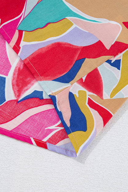 Chemisier rose à imprimé abstrait, manches volantées, col en V fendu et noué