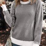 Pull noir à col ras du cou et épaules tombantes et bords contrastés