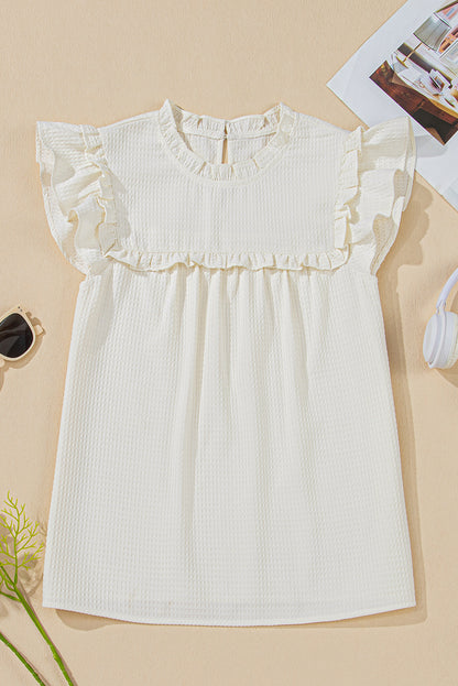 Chemisier blanc uni en tricot gaufré à volants