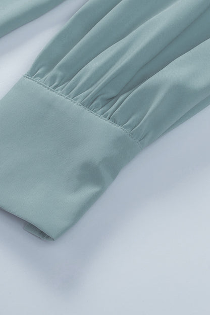 Chemisier boutonné à manches bouffantes de couleur unie