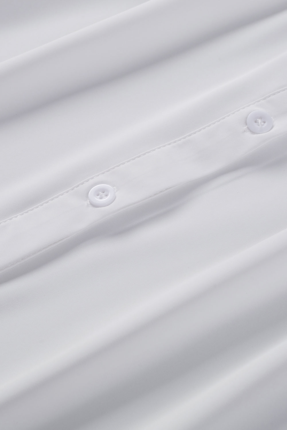 Chemisier boutonné à manches bouffantes de couleur unie