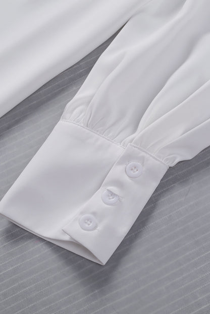 Chemisier boutonné à manches bouffantes de couleur unie