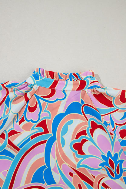 Chemisier rose à imprimé abstrait, col à volants et manches à volants