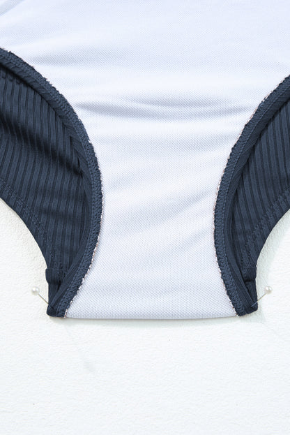 Maillot de bain une pièce bleu marine côtelé avec cordon de serrage et découpes sur les côtés