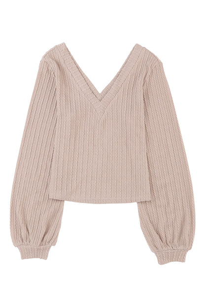 Haut noir en tricot jacquard à col en V et manches lanternes