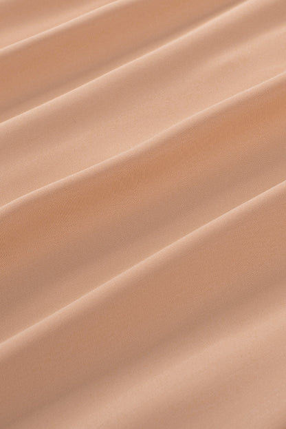 Chemisier boutonné à manches bouffantes de couleur unie