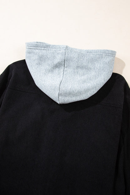 Veste-chemise noire en velours côtelé avec capuche et poches à cordon