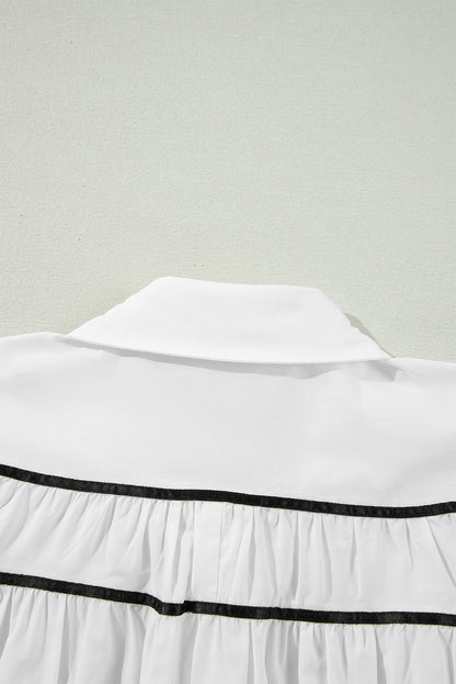 Chemise à manches bouffantes et volants avec col et nœud papillon en ruban passepoilé blanc et noir