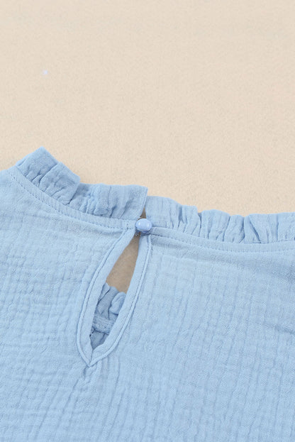 Chemisier texturé à manches flottantes et col à volants 