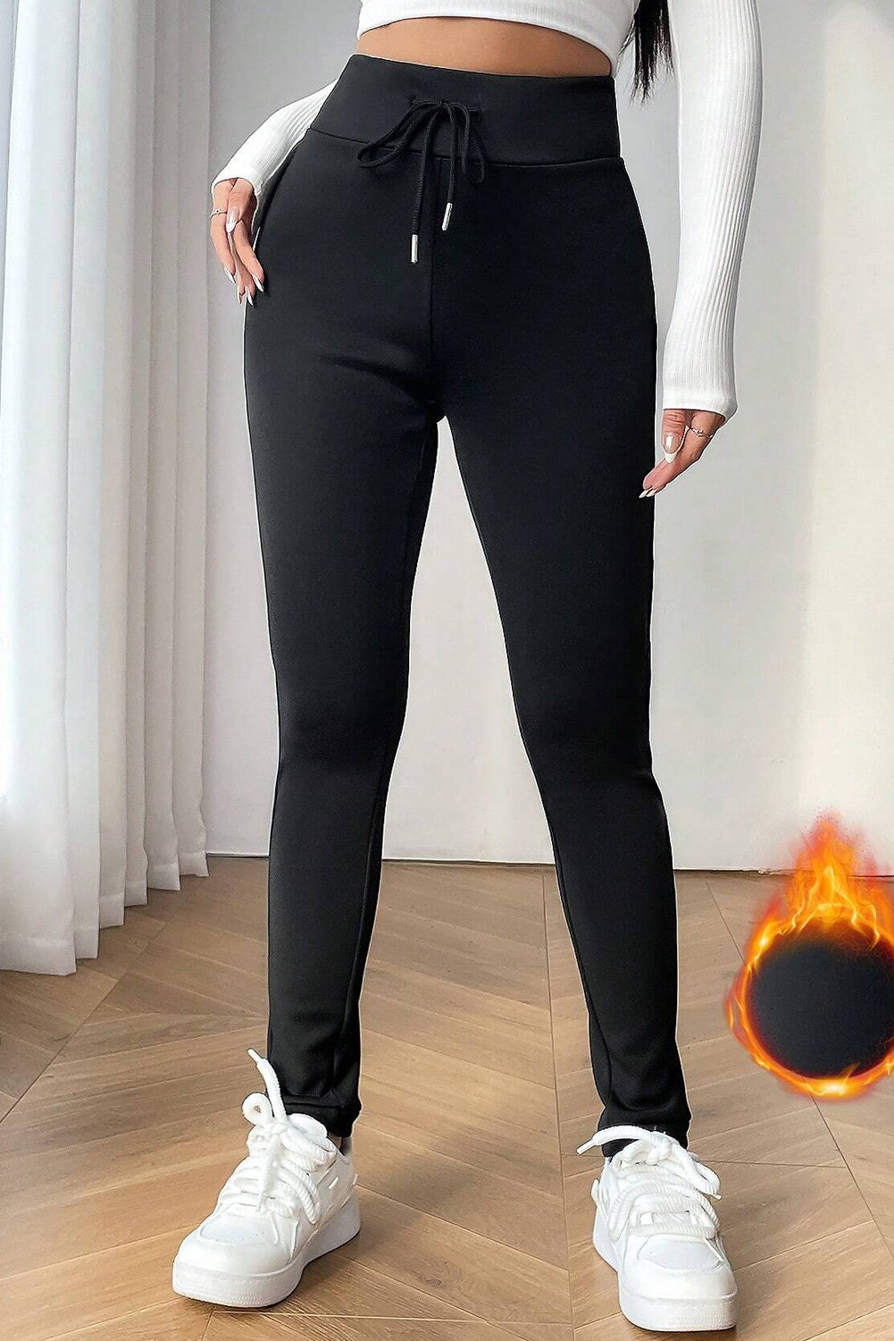 Leggings noirs unis doublés thermiquement avec cordon de serrage à la taille