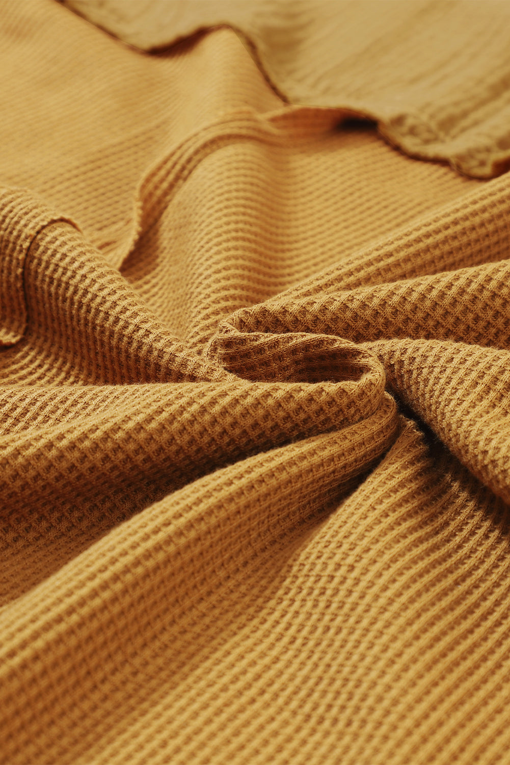 Haut en tricot gaufré à manches bouffantes et coutures apparentes