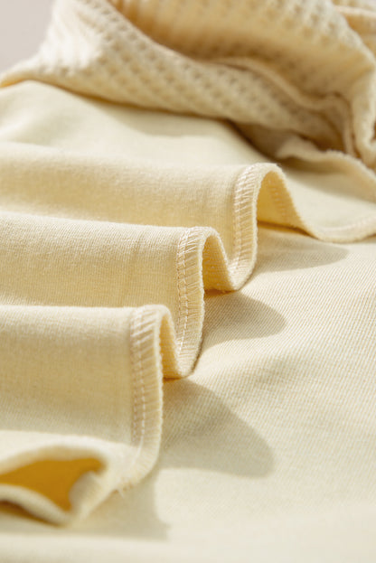 Haut beige à manches longues en tricot thermique avec coutures apparentes