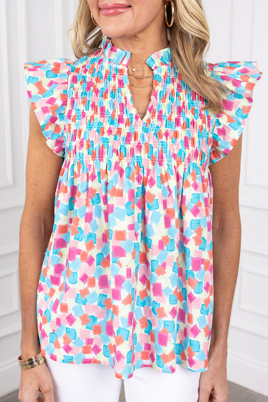 Chemisier bleu ciel à imprimé abstrait et à volants