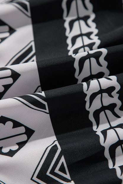 Robe noire à volants et col en V à imprimé géométrique