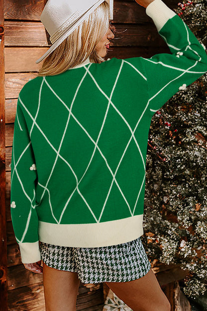 Pull col montant à motif losanges vert foncé avec pompons contrastés