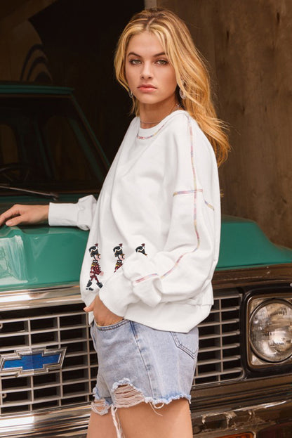 Sweat-shirt blanc à motif poupée Casse-Noisette à paillettes et points colorés