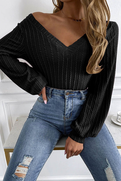 Haut noir en tricot jacquard à col en V et manches lanternes