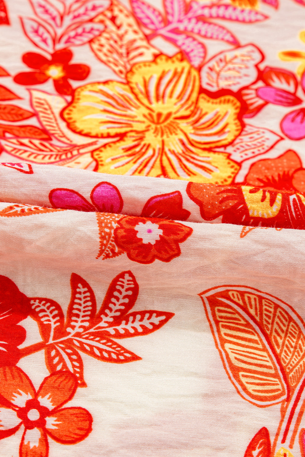 Chemisier orange à imprimé floral, boutons nacrés, manches longues bouffantes et trou de serrure