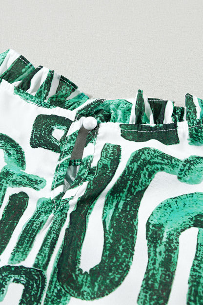 Haut imprimé vert noirâtre à manches bouffantes et col à volants