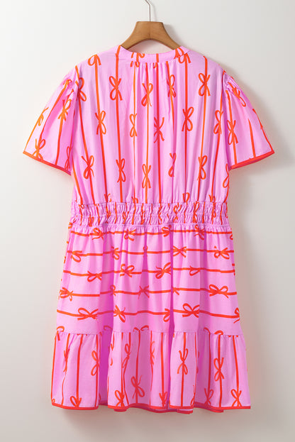 Robe grande taille à volants et taille cintrée avec nœud rose