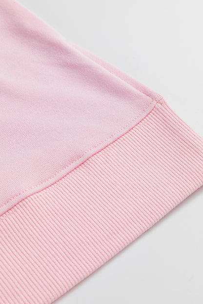 Haut décontracté rose clair à manches larges et épaules tombantes, motif floral et symbole de la paix