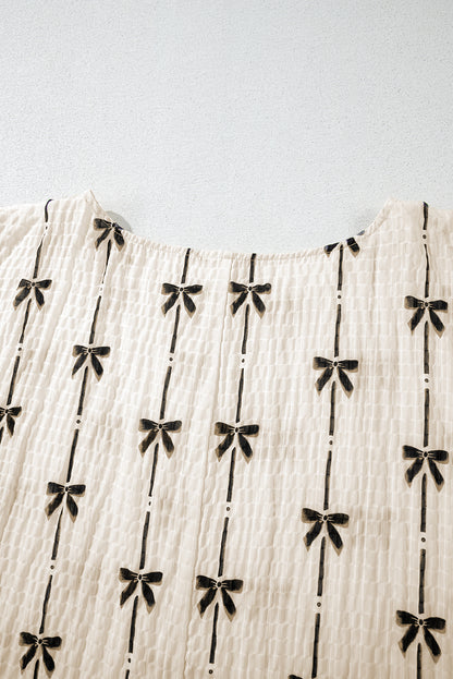 Haut à manches courtes bouffantes et imprimé nœud beige