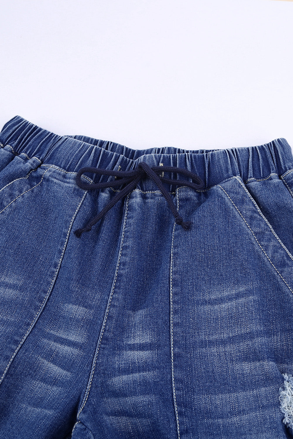 Joggers de mezclilla desgastados con bolsillos