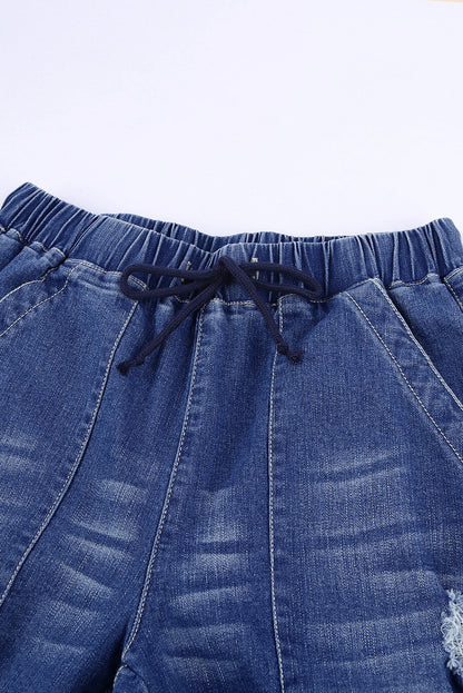 Joggers de mezclilla desgastados con bolsillos