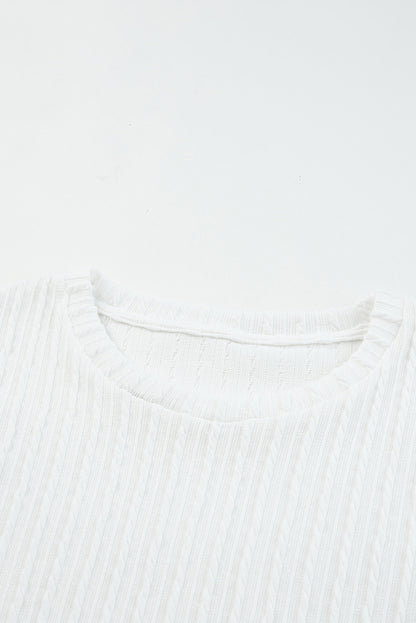 Blusa de punto texturizada con mangas de malla y apliques florales 