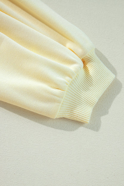 Sweat-shirt beige à manches bouffantes et fleurs en guirlandes